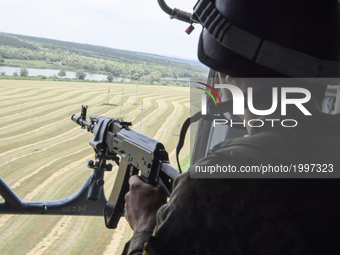 A Ukrainian serviceman in a military helicopter , Donetsk region, Ukraine, June 1, 2017. (