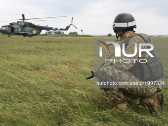  Ukrainian serviceman  near the military helicopter , Donetsk region, Ukraine, June 1, 2017. (