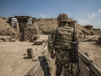 Soldier of Nagorno Karabakh army makes a patrol in the trenches close to Martakert frontline, less than 300 meters of the Azerbaijan army po...