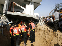 Palestinian rescue workers search the rubble for survivors following an Israeli military strike on Rafah, in the southern Gaza Strip, on Aug...