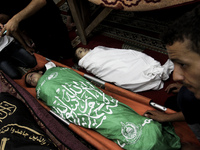 The bodies of girls from Alasar family during their funeral in the mosque in the al-Nusairat refugee camp on 01 August 2014.  whose killed i...