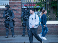Armed police officers patrol to offer safety and security at the One Love Manchester benefit concert inside Trafford Town Hall in Trafford,...