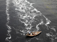 (Archive) March 22, 2017- Dhaka, Bangladesh – A Bangladeshi boatman ride his boat and crossing in the polluted water near the riverbank of B...