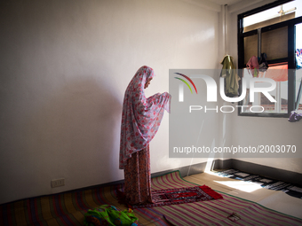 Displaced muslim woman offer a prayer while living in a temporary evacuation center at Provincial Capitol Complex while government troops ar...