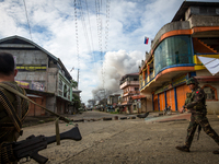 A smoke rages at houses following airstrikes by the Philippine Air Force in Marawi, Southern Philippines, June 6, 2017. Philippine military...