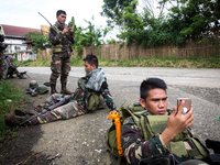 Government troops uses their mobile phones to contact their love ones before going to fight with Islamist rebel in Marawi City, Southern Phi...