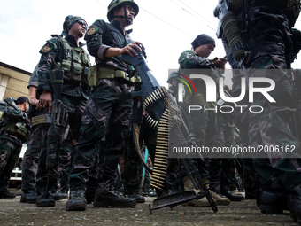 Striking force of the Philippine National Police or RPSB listens to instructions of the officer before search operation of firearms and expl...