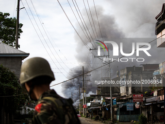 A smoke rages at houses following airstrikes by the Philippine Air Force in Marawi, Southern Philippines, June 6, 2017. Philippine military...