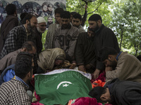 Relatives cry during the funeral of a teenager Adil Magray at Shopian, about 60 kilometers (38 miles) south of Srinagar, Indian-administered...