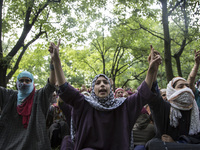 Kashmiri women villagers shout pro-freedom slogans during the funeral of a teenager Adil Magray at Shopian, about 60 kilometers (38 miles) s...
