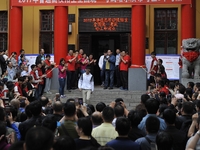 Students with parents and teachers pose for photos in front of the school where their students are attending the China's annual national col...