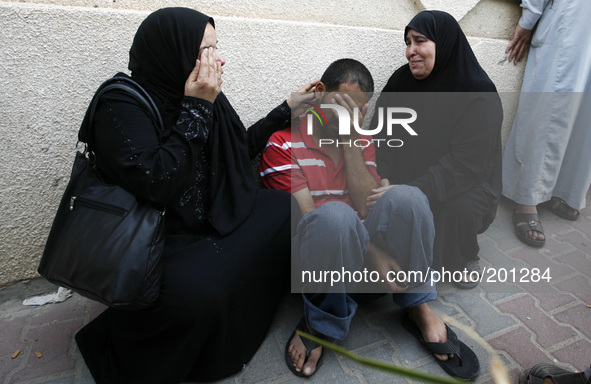 A Palestinian relatives mourn on one of their relatives at the al-Kuwaiti hospital a after an Israeli air strike in Rafah, in the southern G...