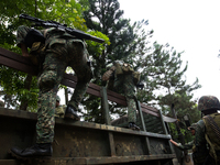 Philippine marines gets on to the truck as they prepare to attack the Islamist rebels in Marawi, southern Philippines on June 9, 2017. Phili...