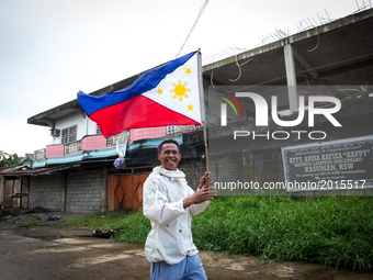 Civilian runs with a Philippine flag in war-torn Marawi City in preparation for the celebration of Independence Day on June 12, Lanao del Su...