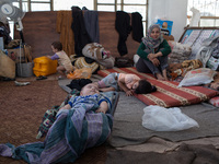 A Palestinian family takes refuge at a shelter in Gaza city center after losing their home to an Israeli air strikes. According to United Na...