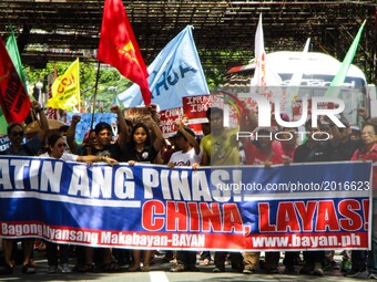 Protesters march towards the Chinese consulate during a rally coinciding the 119th Philippine Independence Day in the financial district of...