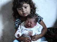 A new baby in Gaza today her name is “Gaza Tqawem Nedal Hojela” she had been born in a UN school, on August 2, 2014 after her family flee th...