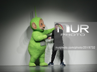 Designer Bobby Abley (R) poses with a Teletubby on the runway at the Bobby Abley show during the London Fashion Week Men's June 2017 collect...