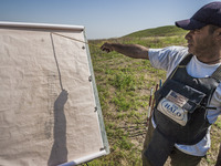 Deminers team coordinator of HALO Trust shows a landmines map of the hills of Nagorno Karabakh, on 13 June 2017. Mines still remain after 25...