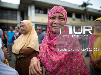 Muslim residents smile before a symbolic flag raising ceremony in celebration of the Independence Day in Marawi City, Philippines on June 12...