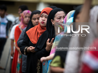 Muslim residents are seen praying during a symbolic flag raising ceremony in celebration of the Independence Day in Marawi City, Philippines...
