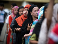 Muslim residents are seen praying during a symbolic flag raising ceremony in celebration of the Independence Day in Marawi City, Philippines...