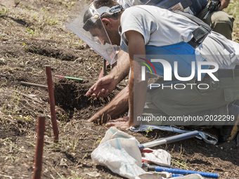 Deminers of HALO Trust organisation dig to extract a landmine previously detected in the hills of Nagorno Karabakh. Mines still remain after...