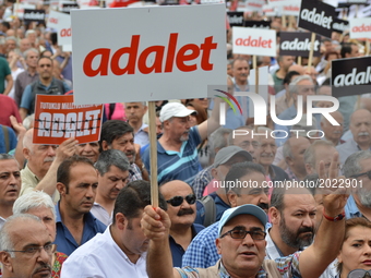A man holds a banner that reads 'Justice' in Turkish during the 'Justice March' to protest against the Turkish government held by the main o...