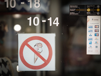 A sign at a leather shop is seen forbidding the consumption of ice cream 15 June, 2017. (
