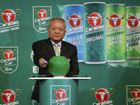 Sathien Setthasit CEO of Carabao Group draws a number during the first draw for the upcoming season's EFL Cup football tournament at Bangkok...