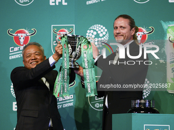 Sathien Setthasit CEO of Carabao Group (L) and Emmanuel Petit former French international footballer raise the EFL Carabao Cup after the fir...