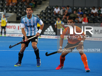 L-R Joaquin Menini of Argentina  and Firhan Ashaari of Malaysia
during The Men's Hockey World League Semi-Final 2017 Group A match between A...