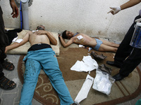 A wounded Palestinian men arrives at the hospital a after an Israeli air strike, in Rafah, in the southern Gaza Strip on August 3, 2014. At...