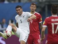 Michael Boxall  (L) of the New Zealand national football team and Fedor Smolov of the Russian national football team vie for the ball during...