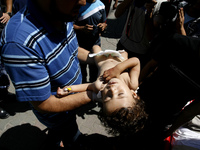 A wounded Palestinian child arrives at the hospital a after an Israeli air strike, in Rafah, in the southern Gaza Strip on August 3, 2014. A...