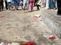 Palestinian walk past trails of blood following an Israeli military strike on a UN school in Rafah, in the southern Gaza Strip on August 3,...