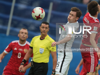 Michael McGlinchey (L) of the New Zealand national football team and Alexander Golovin of the Russian national football team vie for the bal...