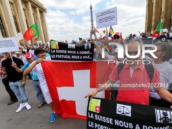 Victims of toxic investments made by former Banco Espirito Santo (BES) now Novo Banco (New Bank) hold a Swiss flag in front of the Eiffel to...