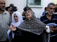 Relatives mourn during the funeral of at least 9 members of the same al-Ghul family who died after their house was hit by an Israeli air str...