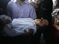 Relatives carry the body of a girl during the funeral of at least 9 members of the same al-Ghul family who died after their house was hit by...