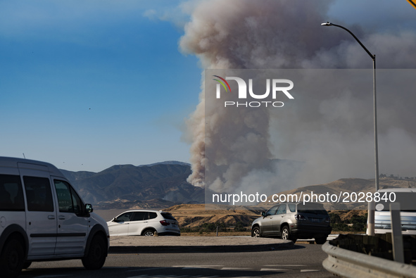 The Castaic Lake wildfire is seen from the 5 Freeway in Castaic, California on June 17, 2017. Castaic, California on June 17, 2017. Firefigh...