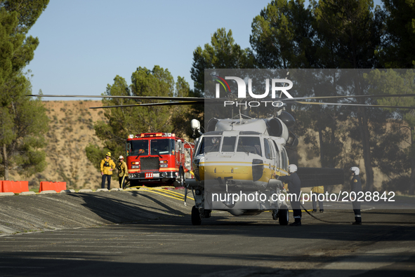 Los Angeles County fire fighting helicopter refilling water at a parking lot during the Castaic Lake fire in Castaic, California on June 17,...