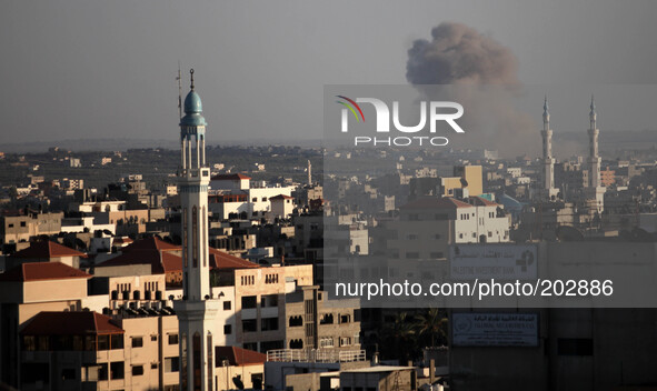 Smoke rises following an Israeli strike in Gaza City on August 3, 2014. At least 10 people were killed in a fresh strike on a UN school in s...