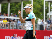 Brooke M. Henderson of Canada acknowledges the gallery after winning the final round of the Meijer LPGA Classic golf tournament at Blythefie...
