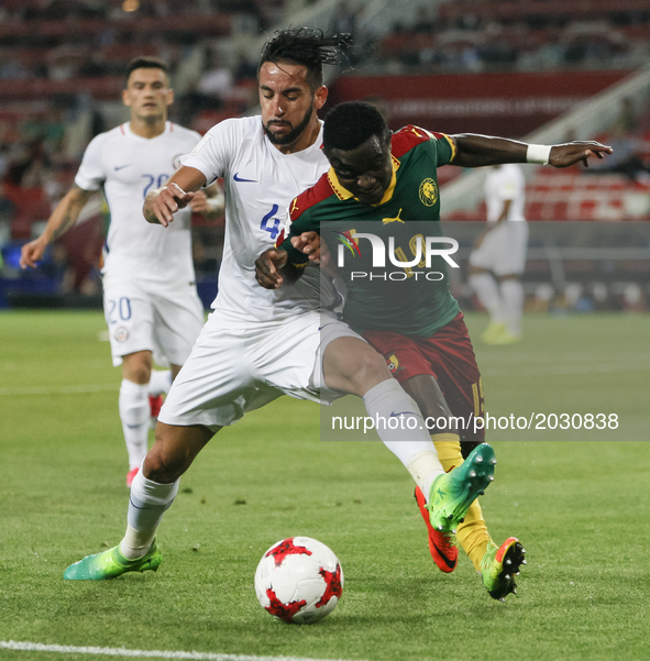 Collins Fai (R) of Cameroon national team and Mauricio Isla of Chile national team during the Group B - FIFA Confederations Cup Russia 2017...