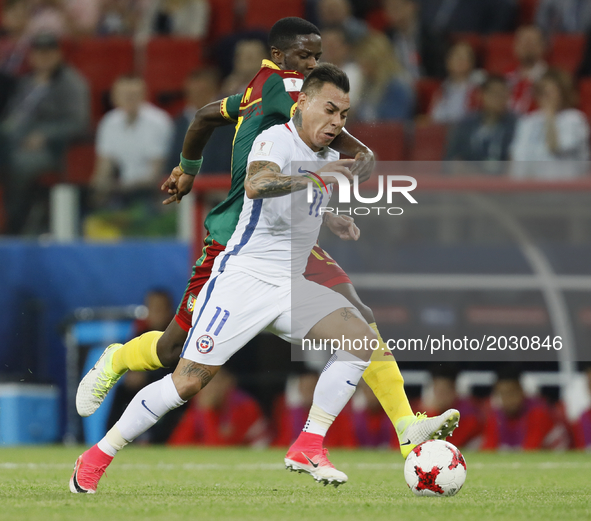 Eduardo Vargas (in front) of Chile national team and Arnaud Djoum of Cameroon national team during the Group B - FIFA Confederations Cup Rus...