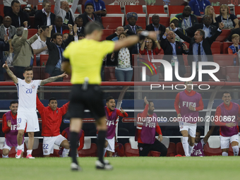 Chile national team bench players and supporters react as referee Damir Skomina allows a goal scored by Eduardo Vargas (not seen) of Chile n...