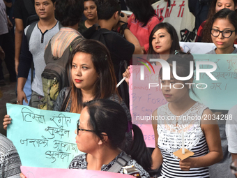 Members of the Gorkha community and JU students hold placards during a protest in support of the Gorkhaland movement in Kolkata on June 20,...
