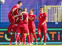 Mijat Gacinovic of Serbia celebrates with team mates after scoring his team's first goal during the UEFA European Under-21 Championship matc...