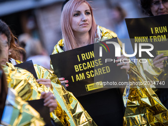 Activists of human rights organization Amnesty International  gather in front of the Pantheon during a Flashmob on World Refugee Day ,in cen...